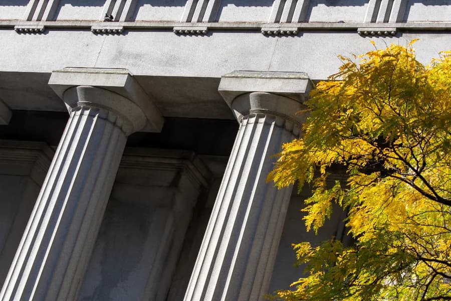 The columned stone portico of a bank building