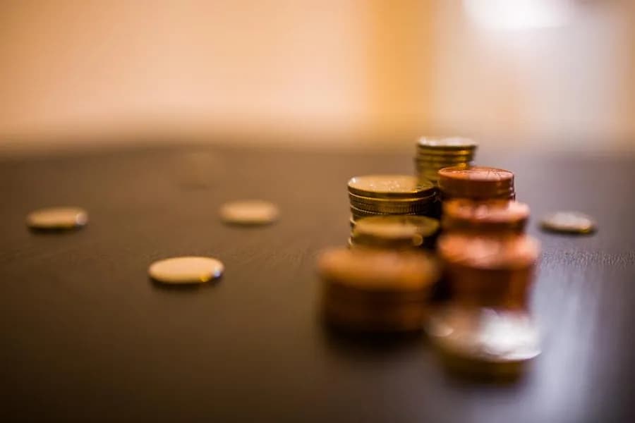 Coins stacked on a wooden table