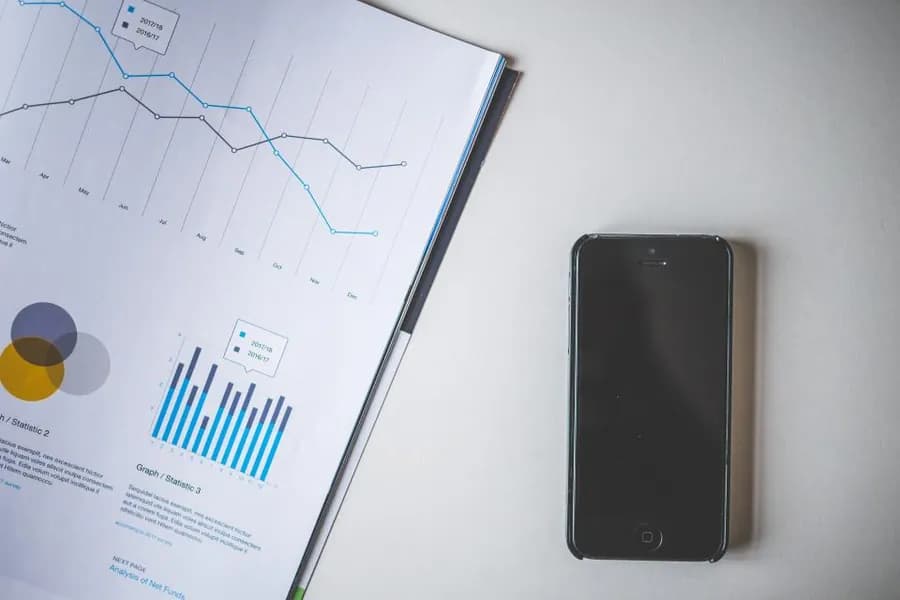 A printed performance report beside a phone