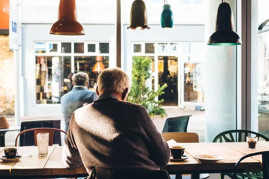 Customers seated at tables inside a cafe
