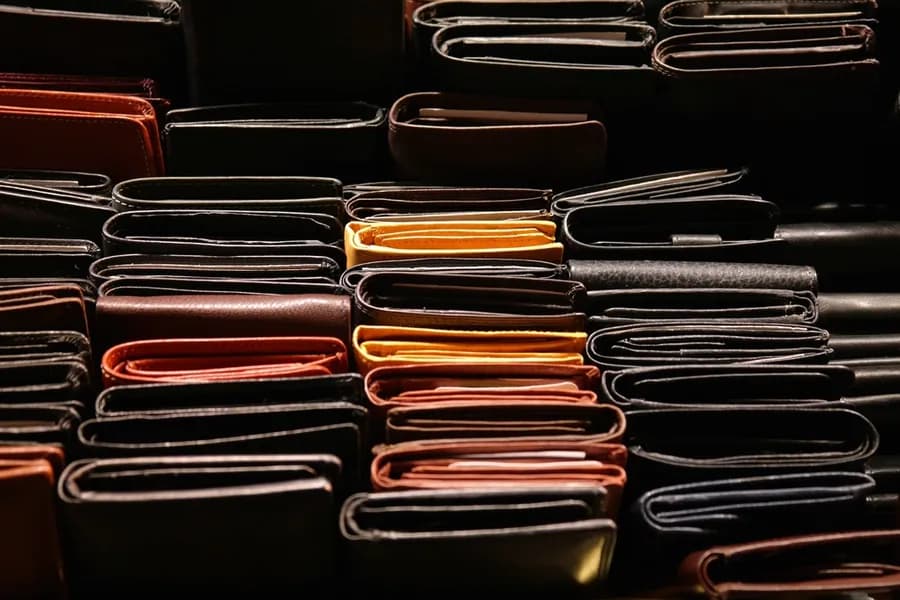 Leather wallets stacked on a surface