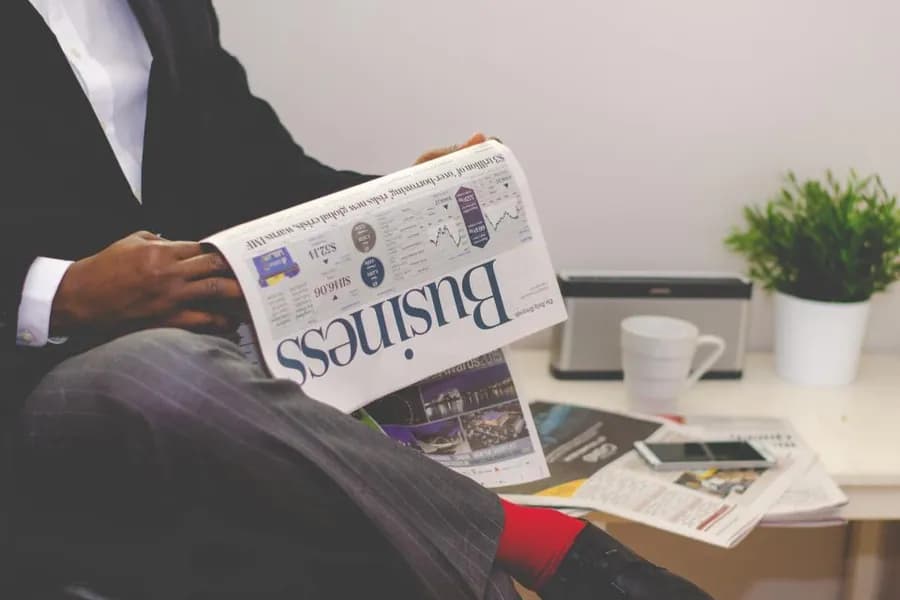 A person reading the business section of a newspaper