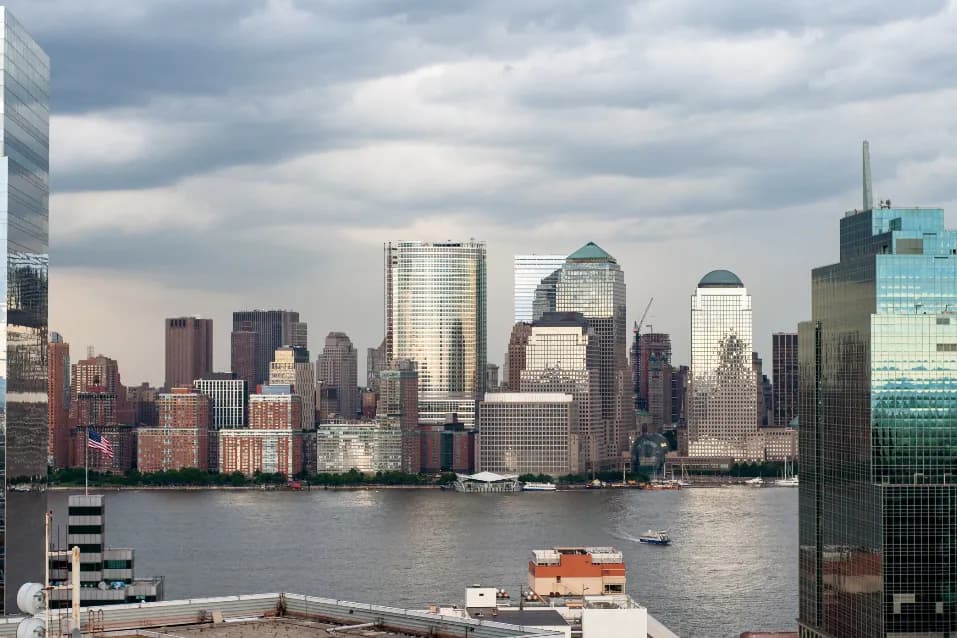 A city skyline of office towers seen across water