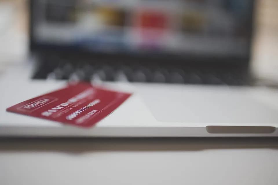A payment card beside a laptop