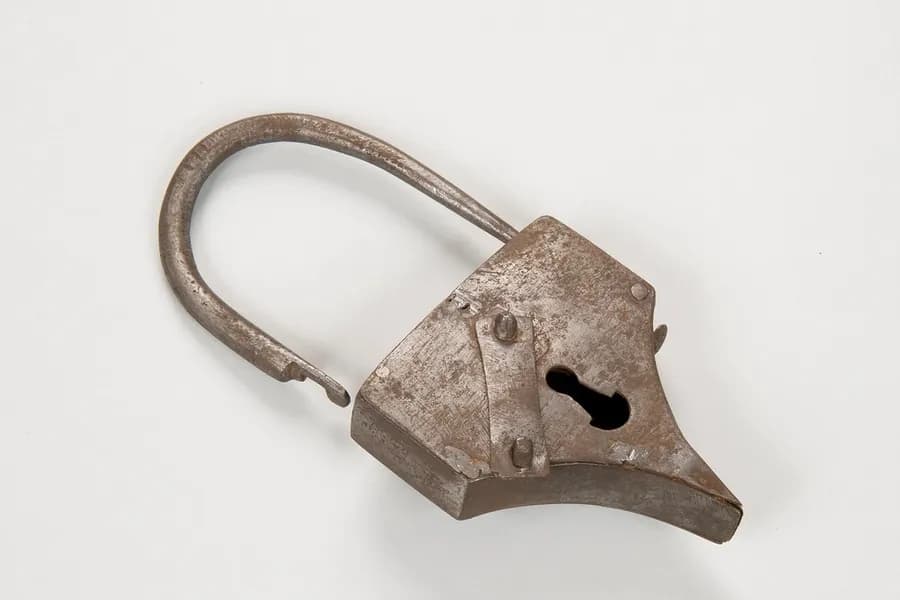 An antique padlock on a white background